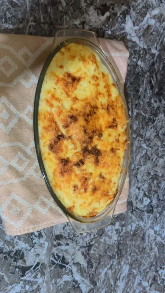 Golden baked mashed potato casserole fresh from oven with crisp cheese top.