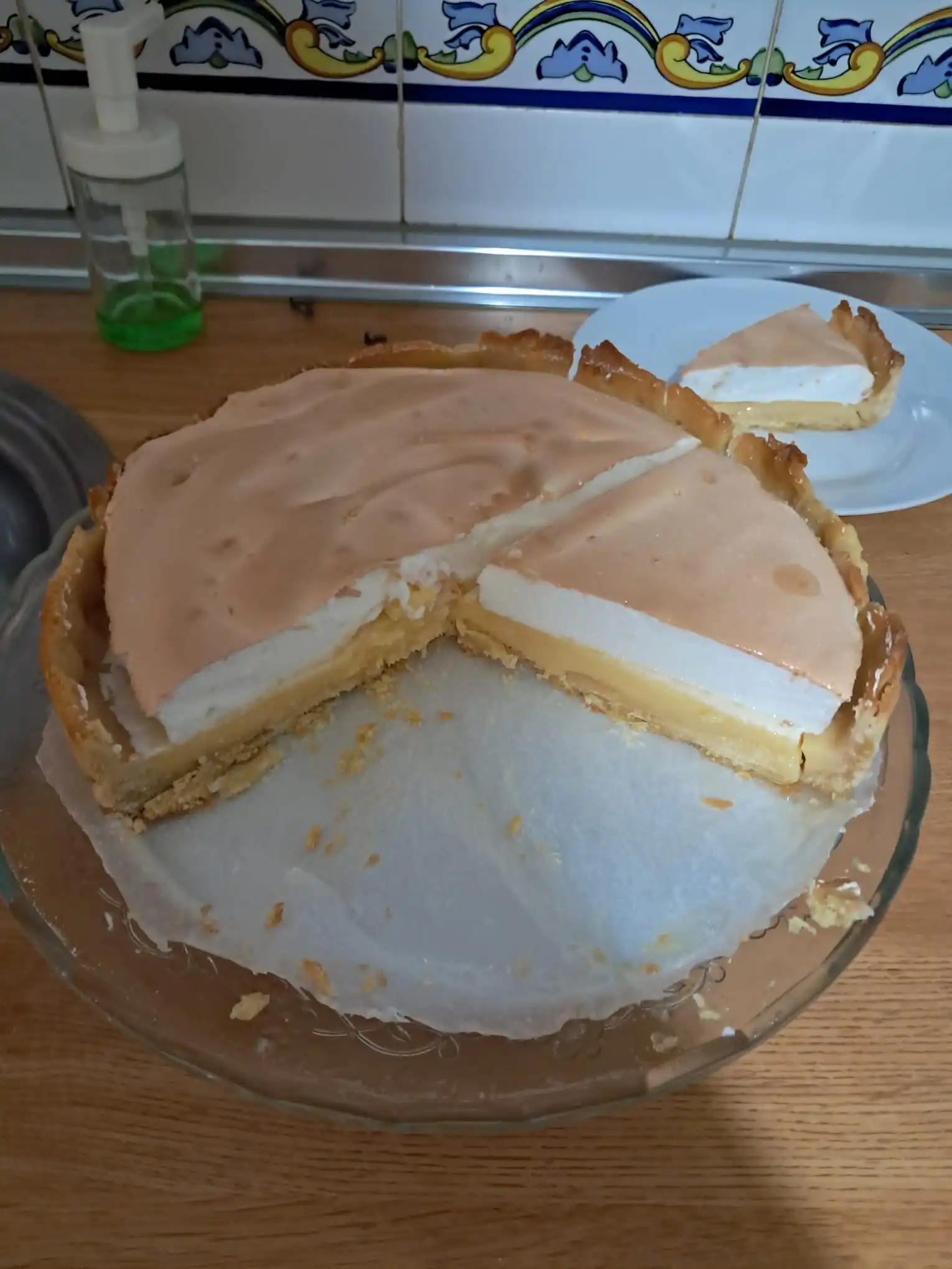 lemon meringue pie with golden toasted meringue and bright yellow lemon curd filling being sliced