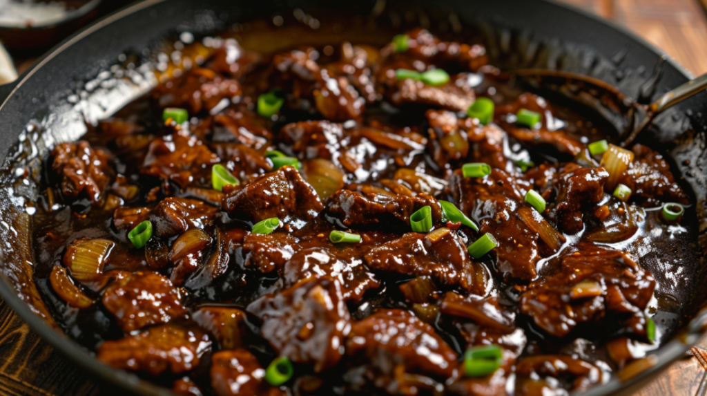Finished Mongolian beef with glossy sticky sauce coating tender beef and vegetables