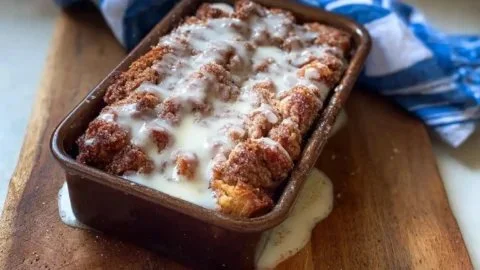Sourdough Apple Fritter Discard Loaf on a wooden table with apples