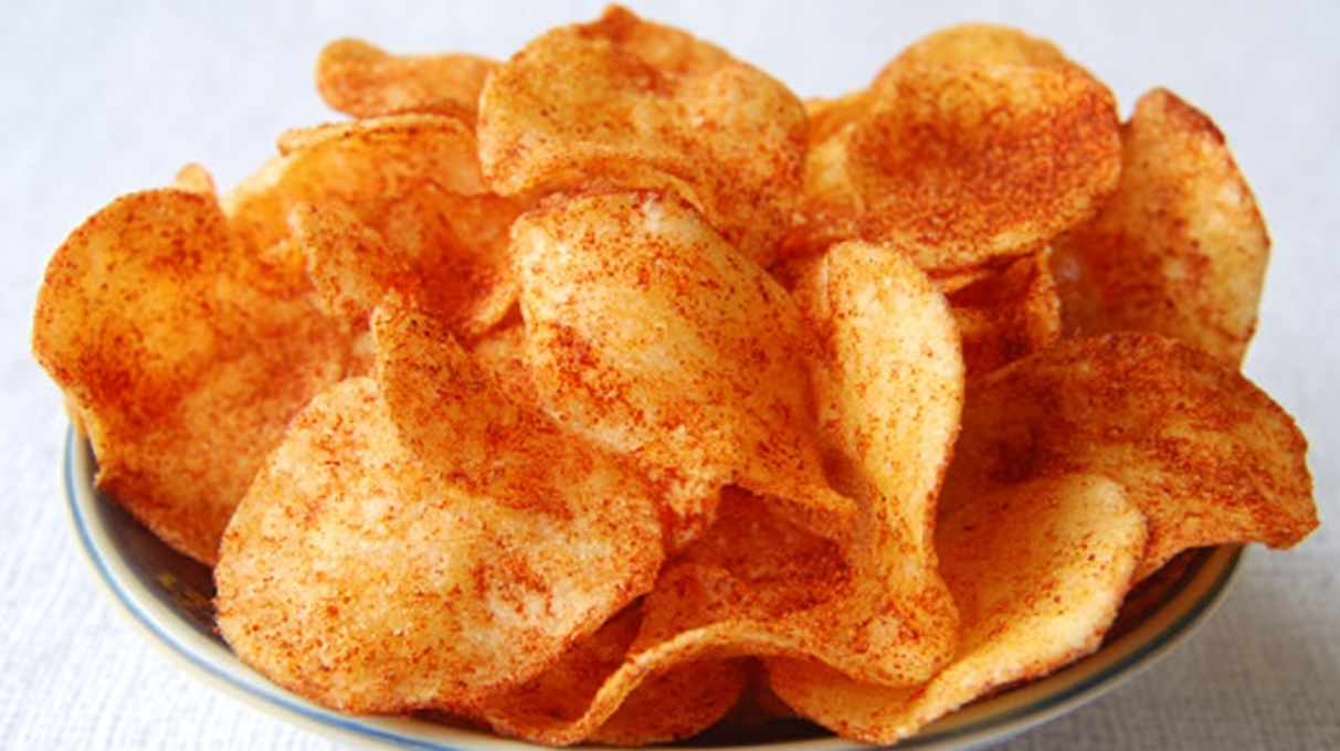 Crispy barbecue potato chips seasoned with smoky BBQ spice and served in a bowl