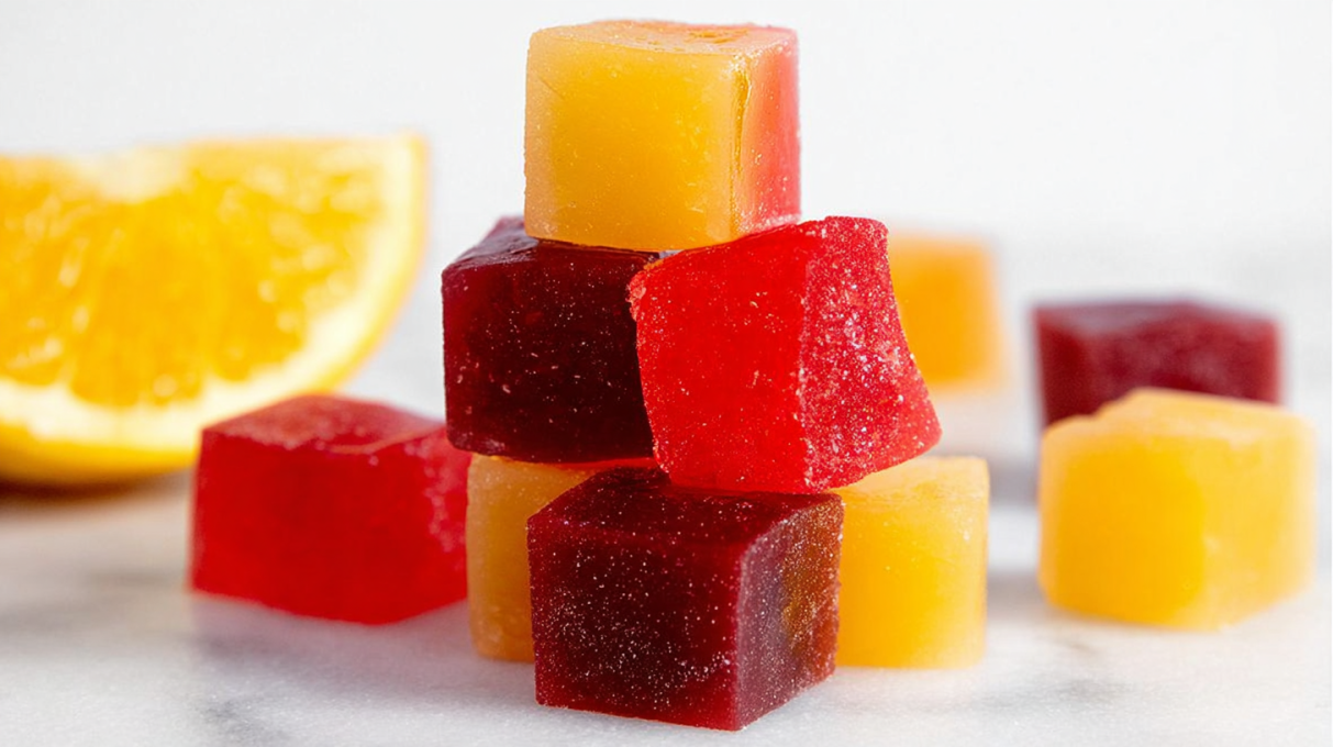 Colorful homemade gummies shaped into bite-sized candies with a glossy, chewy texture