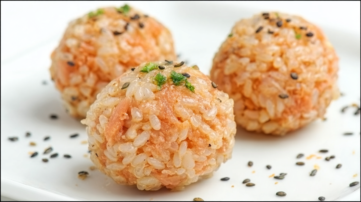 Salmon rice balls made with seasoned rice and flaky salmon, shaped into bite-sized portions