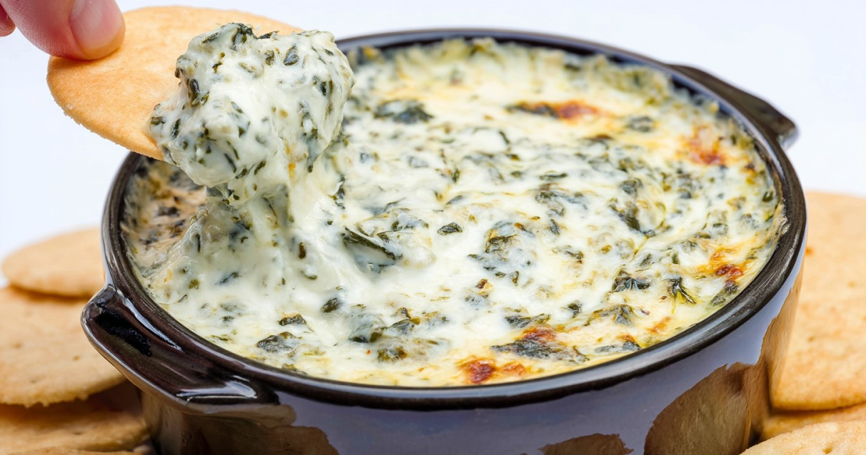 Creamy spinach and artichoke dip baked with melted cheese and served warm with bread or chips