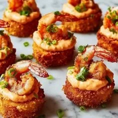 Cheesy shrimp and grits bites on a platter, garnished and ready to serve.