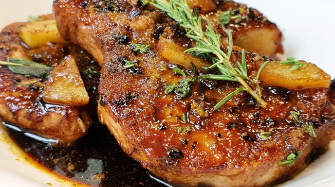 Apple bourbon pork chops cooked in a sweet savory glaze with tender apples and herbs