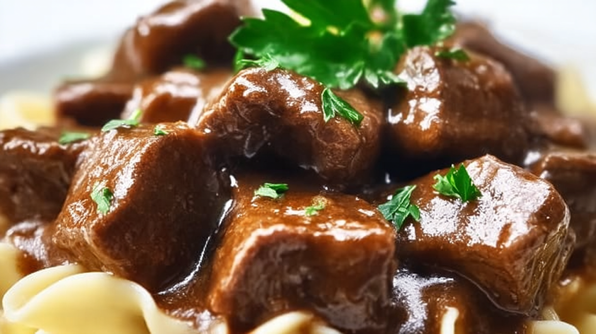 Crockpot beef tips and noodles with tender beef in rich gravy served over egg noodles