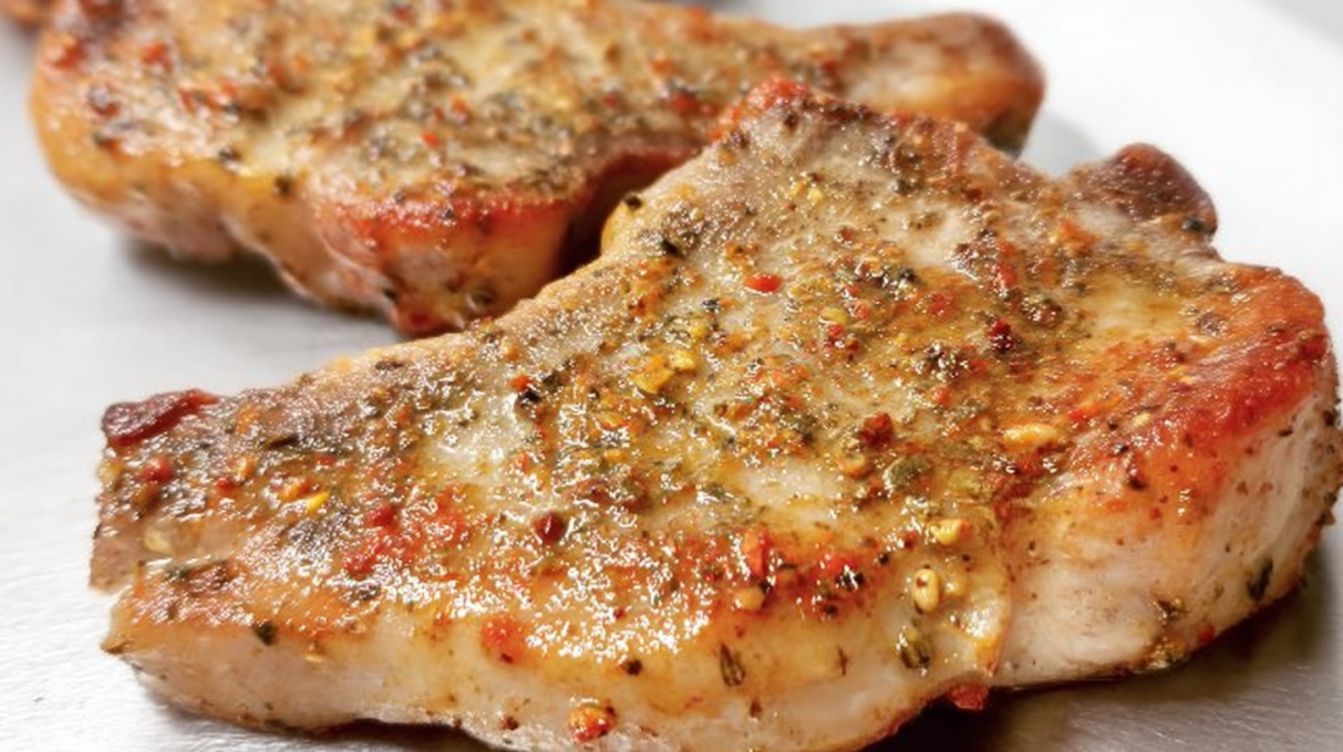 Italian pork chops seasoned with herbs and cooked until juicy, served with a savory sauce