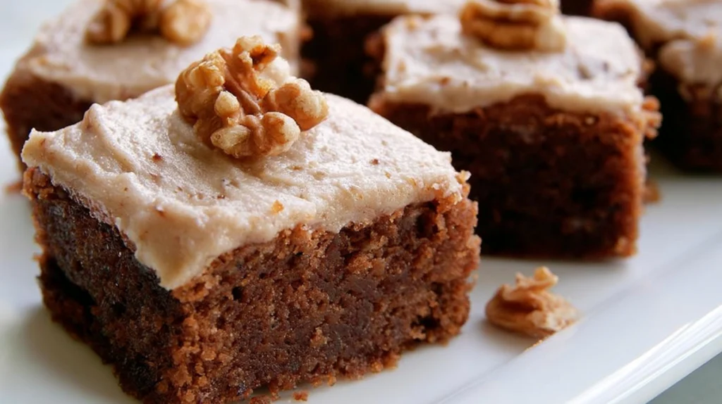 Banana bread brownies baked until soft and fudgy, topped with a smooth vanilla glaze and sliced into squares.