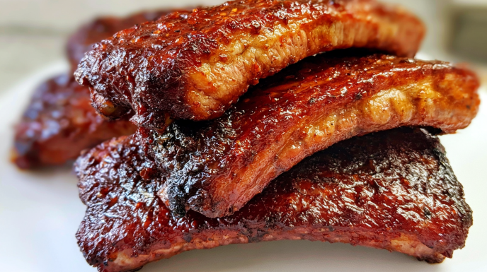 Honey sriracha ribs glazed with a sticky sweet-and-spicy sauce and cooked until tender and caramelized.