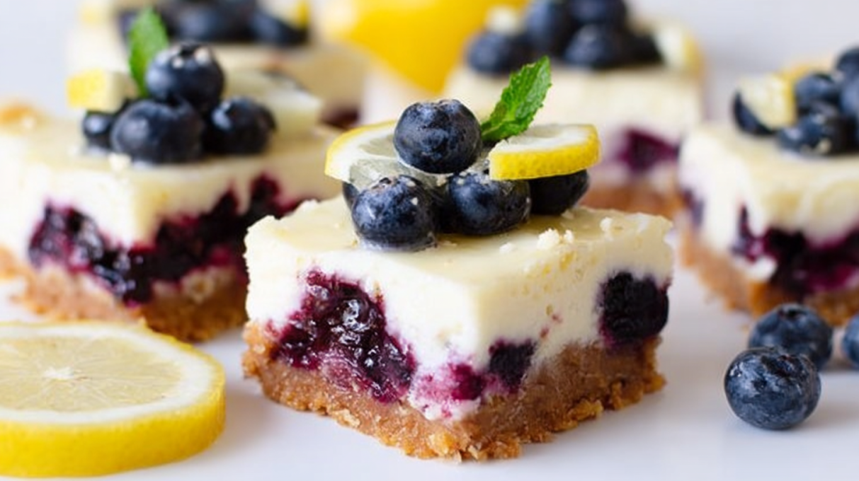 Lemon blueberry cheesecake bars with a creamy cheesecake layer, fresh blueberries, and bright lemon flavor on a buttery crust.