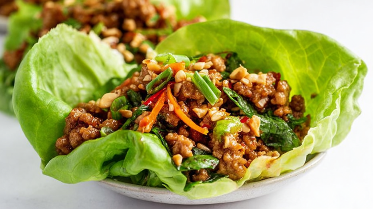 Pork lettuce wraps filled with seasoned ground pork, fresh vegetables, and crunchy lettuce leaves.